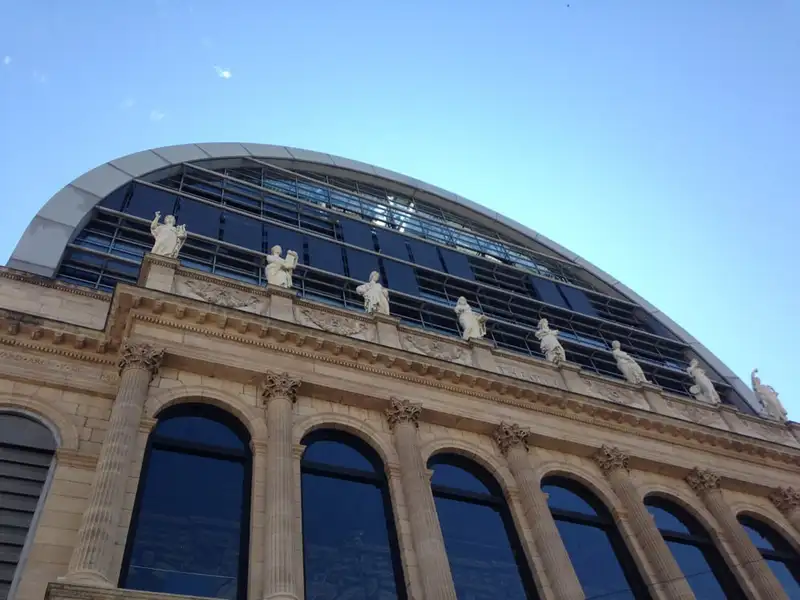 Façade de l’Opéra de Lyon : colonnes, statues et, au-dessus, la façade vitrée en demi-cercle